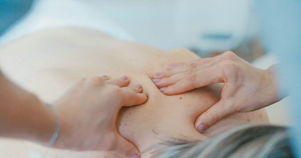 Profissional de estética corporal realizando tratamento nas costas de uma cliente em clínica de estética
