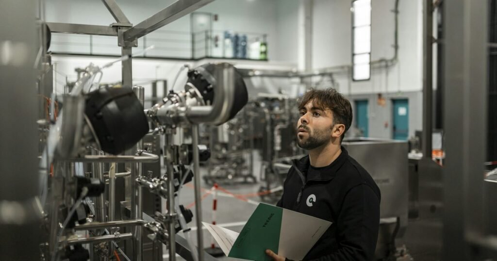 Especialista revisando documentação de controle de qualidade em ambiente industrial, ilustrando o MBA em Gestão da Qualidade e Produtividade da UFEM